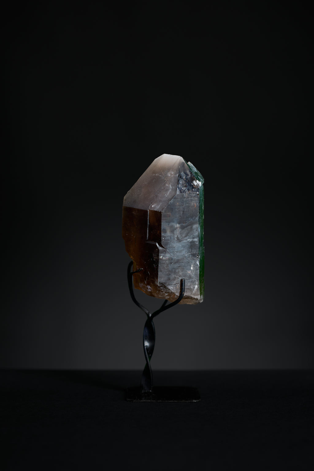 Side view of small smoky quartz point showing elegant natural form