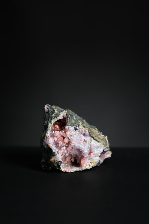 Close-up of amethyst geode interior showing violet crystal formation and calcite detail
