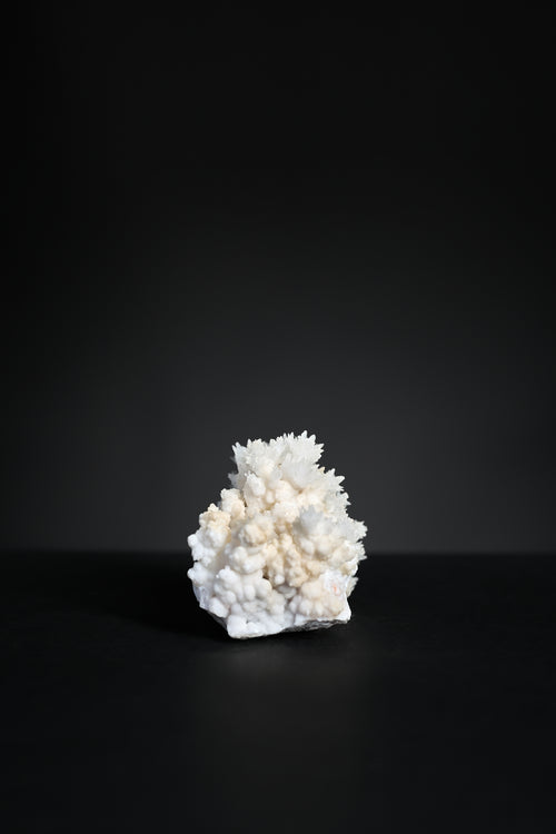 Close-up detail of aragonite crystal structure showing warm mineral tones and texture