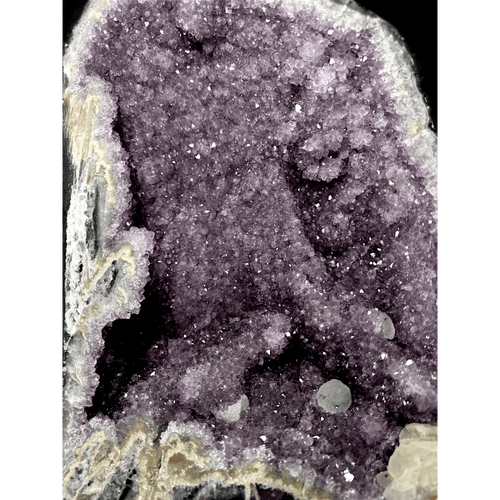 Close-up of amethyst and calcite interplay showing violet and white mineral contrast
