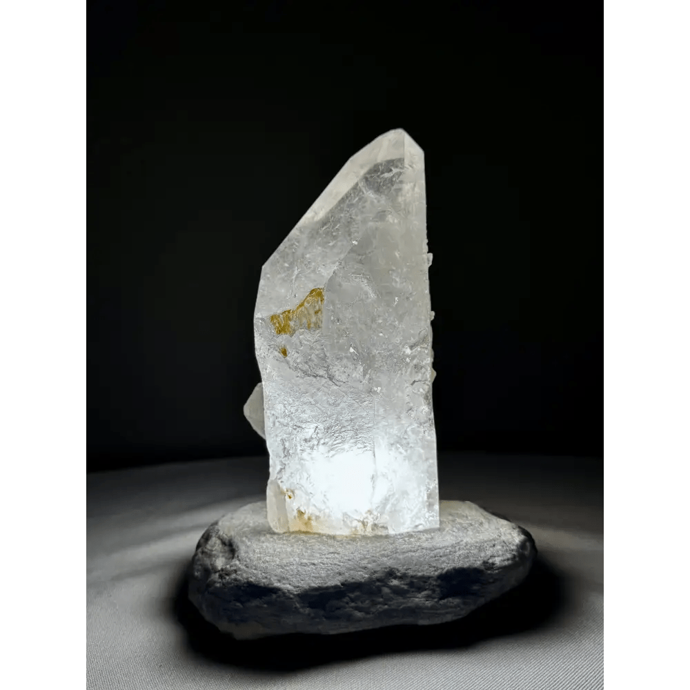 Rock crystal lamp from Brazil with natural yellow hue, illuminated front view
